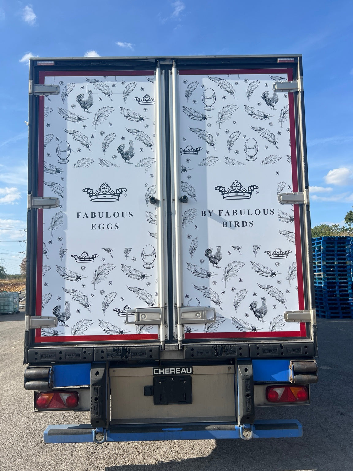 Wrapped trailer rear doors with feather and egg graphics; installed by Wraptastic for another sign shop