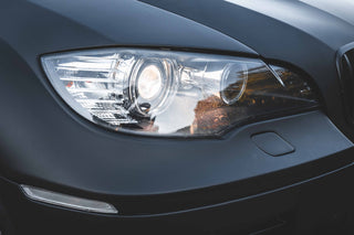 Close-up of a BMW X5 Hamann wrapped in 3M 2080 Matt Black around the front headlight